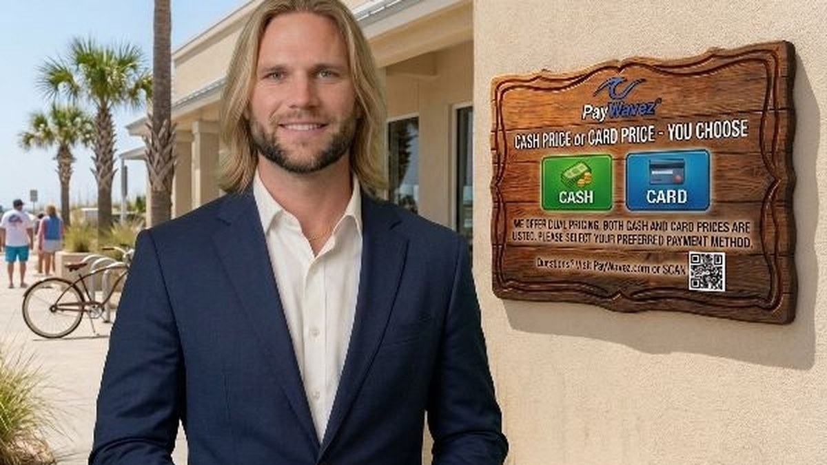Zac Rogers, PayWavez founder, smiling outside a beachside business with a PayWavez sign